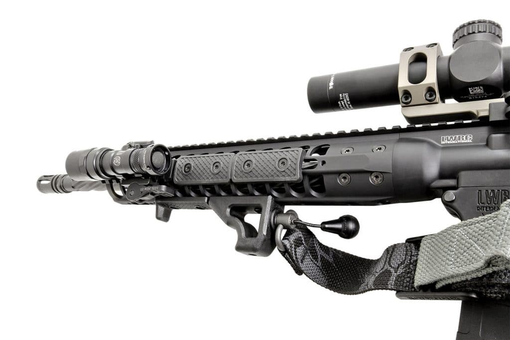Attached to the monoforge upper receiver is a modular, free-float handguard, wearing a handstop and angled foregrip/Q.D. sling mount from the factory.